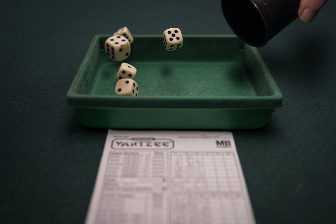 a green tray with dices on top of it