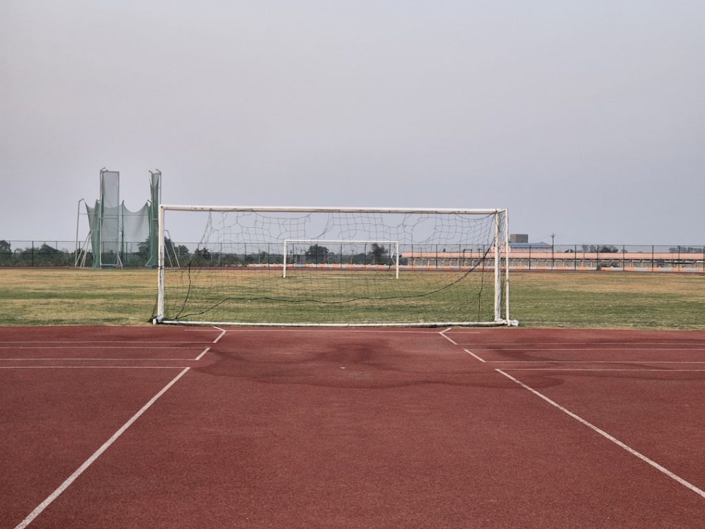 a soccer goal sitting on top of a soccer field