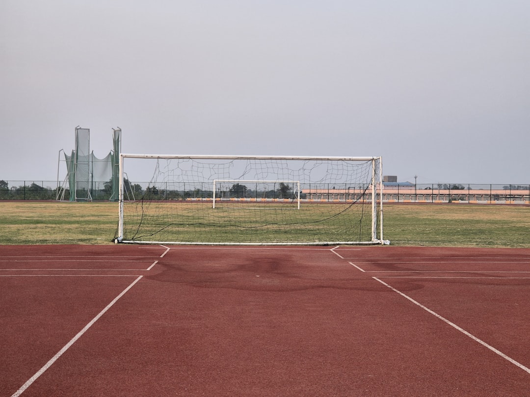 a soccer goal sitting on top of a soccer field