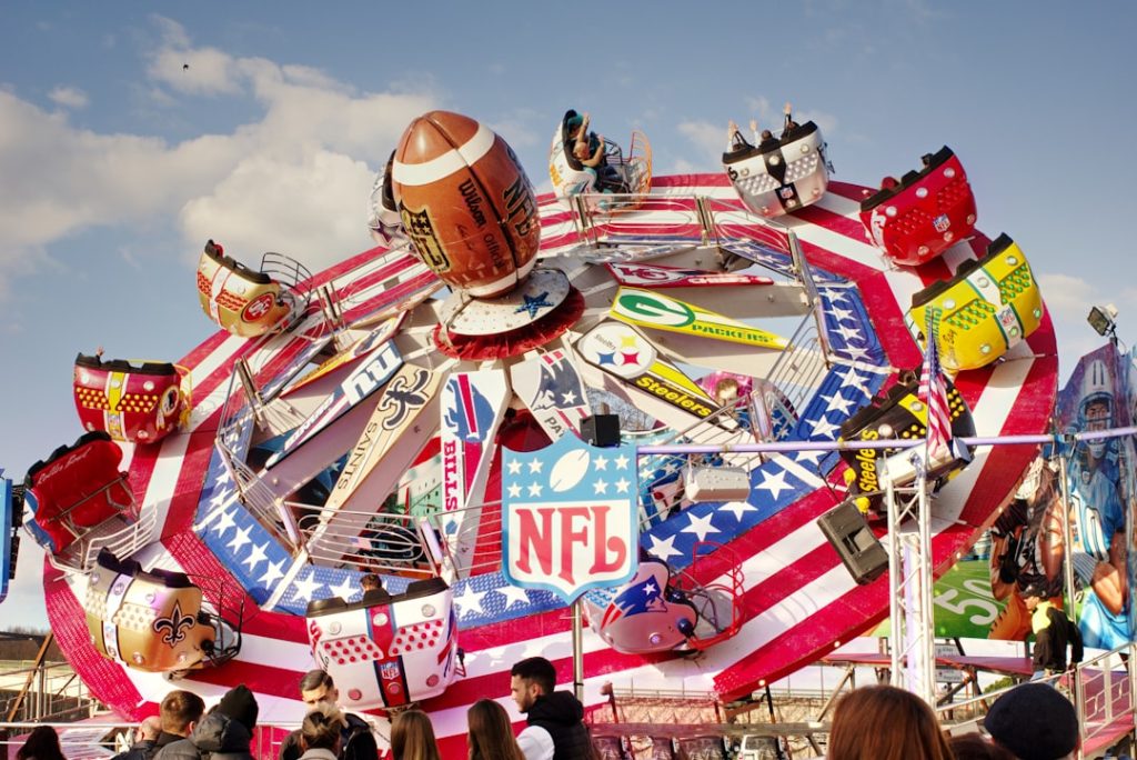 a carnival ride with people standing around it
