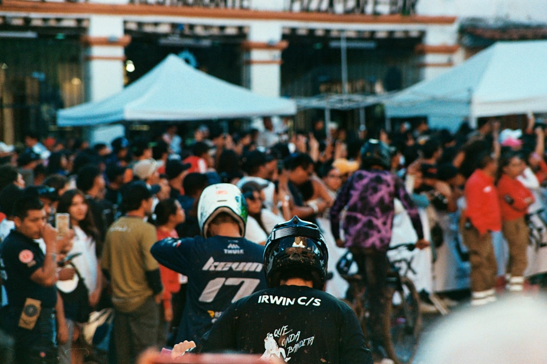 Crowd watches cyclists at an outdoor event