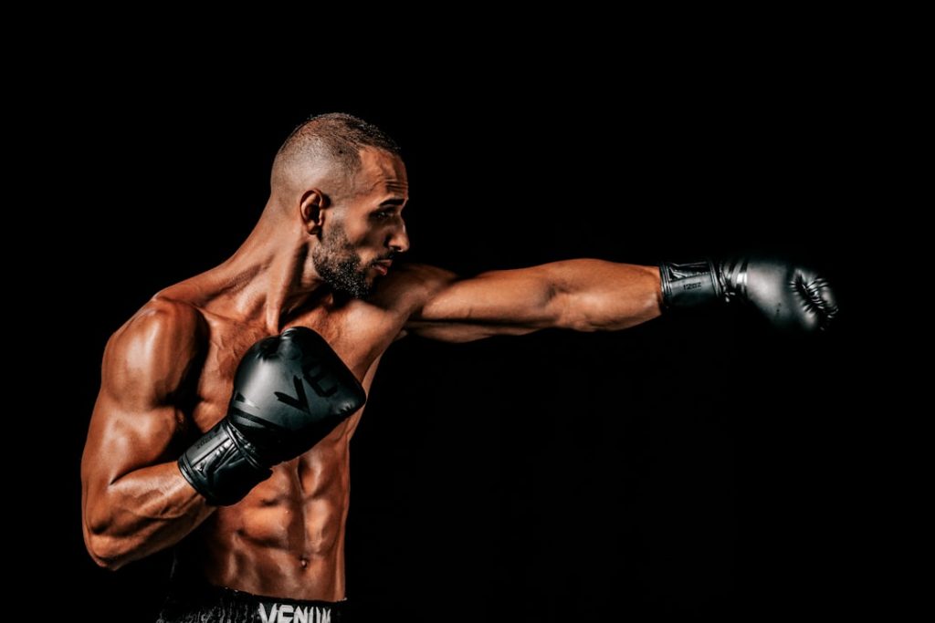 a man with a bald head wearing boxing gloves