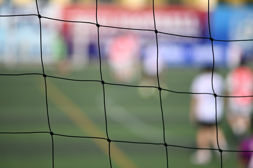 Soccer game viewed through a net
