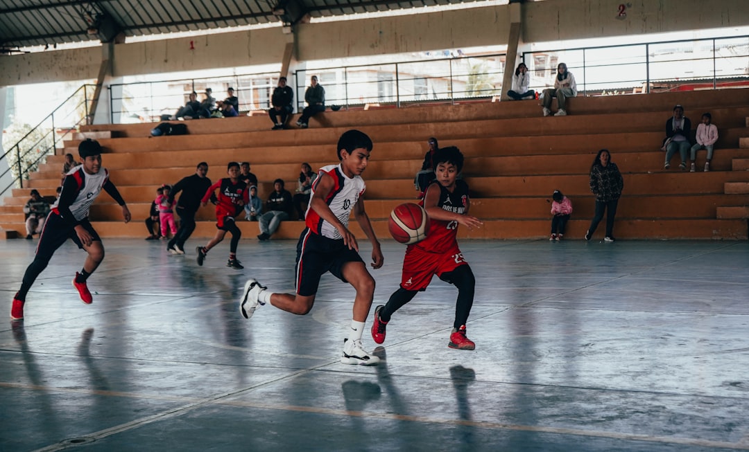 A group of young men playing a game of basketball