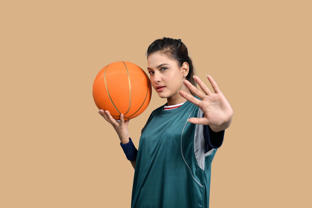 a girl holding a basketball