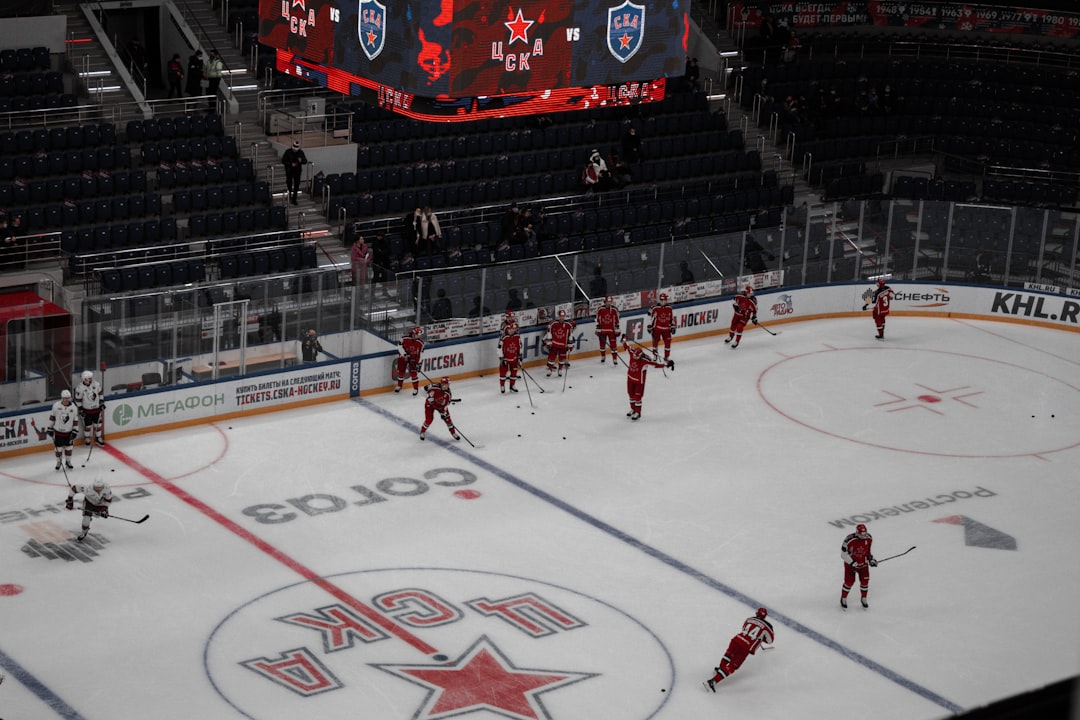 people playing ice hockey on ice stadium
