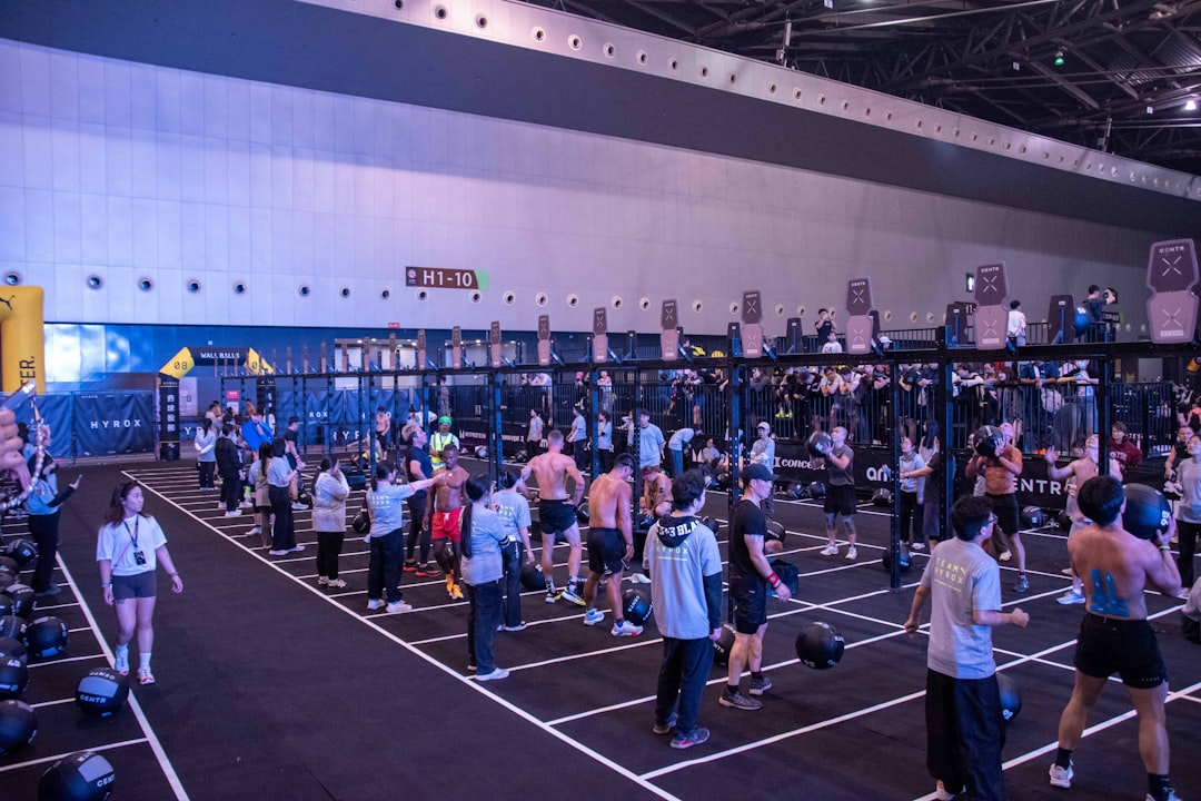 People are working out in a large indoor gym.