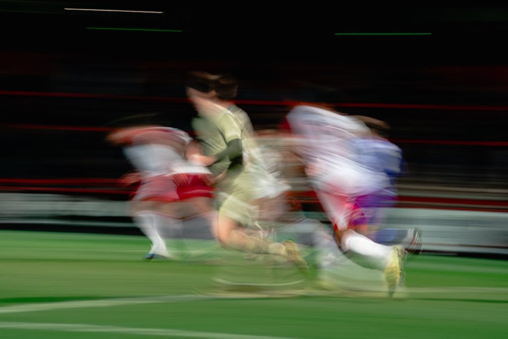 Soccer players running on a field with motion blur