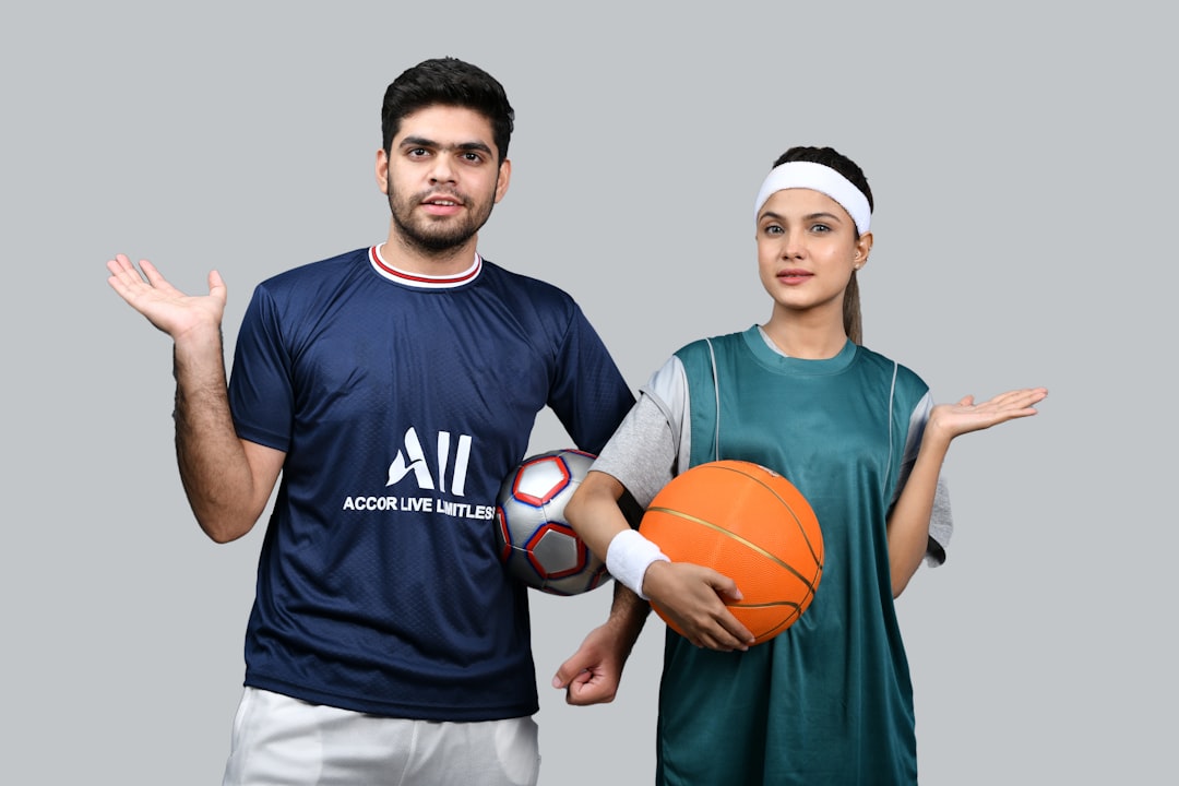 a man and a woman holding a basketball