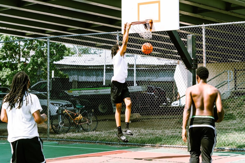 A group of young men playing a game of basketball