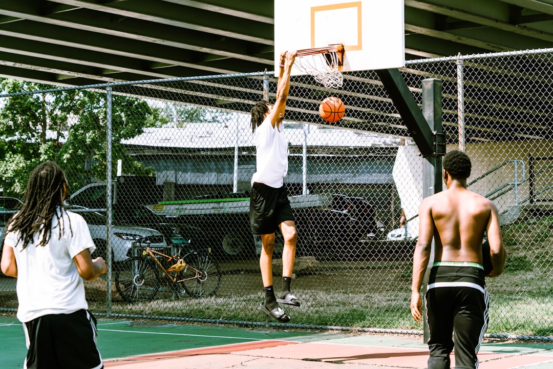 A group of young men playing a game of basketball