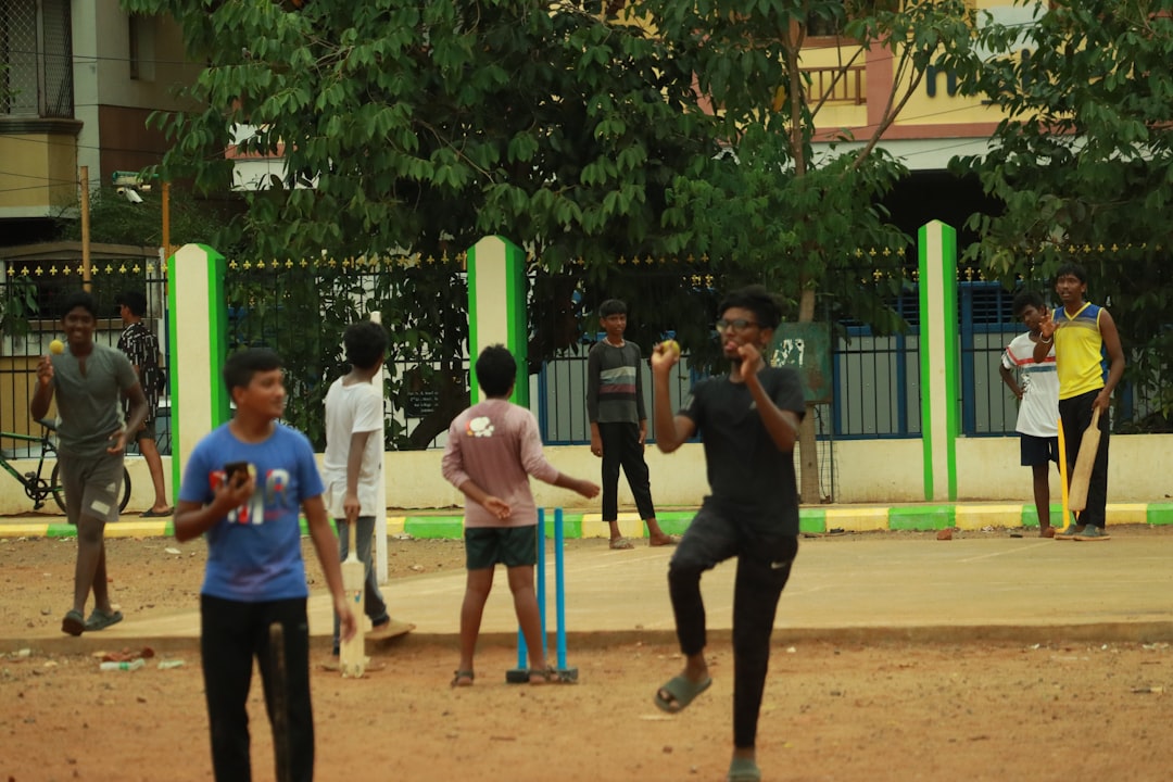 a group of young men playing a game of cricket