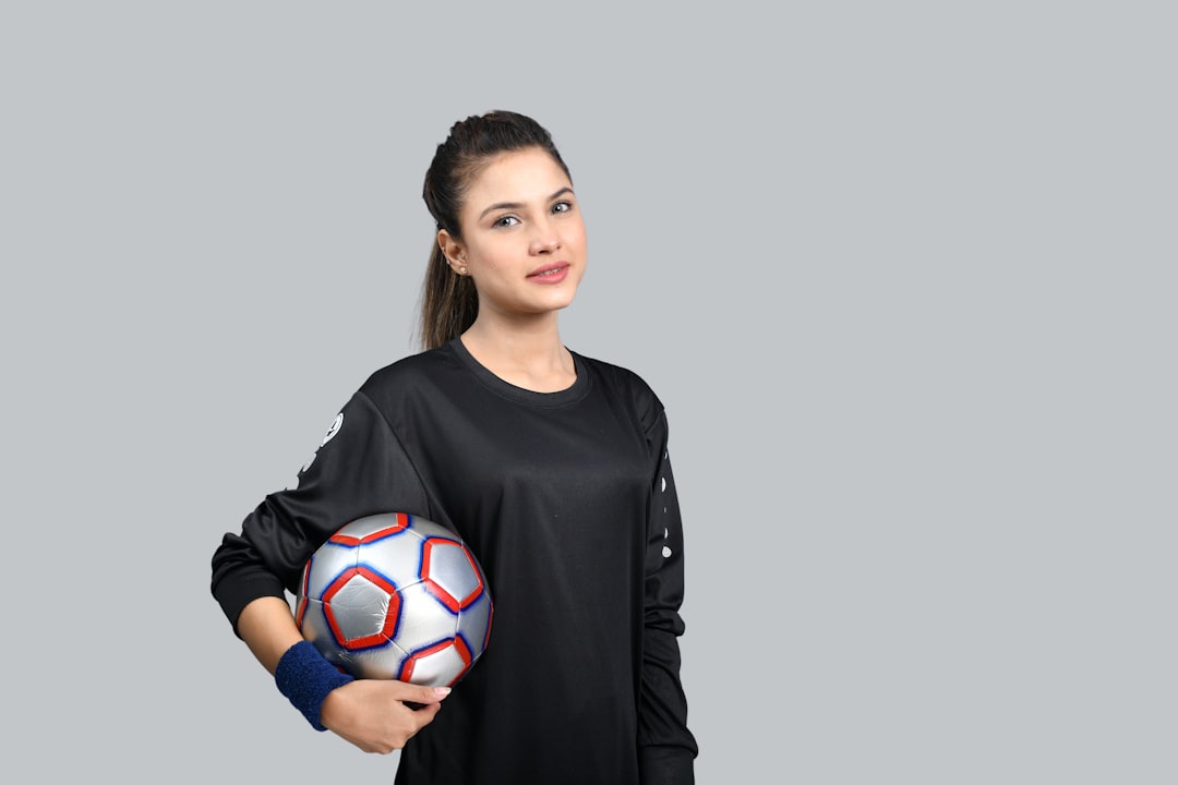 a person holding a football ball