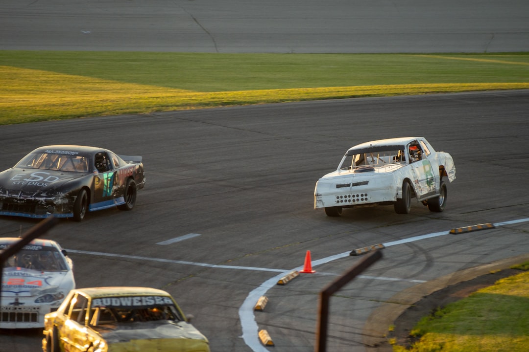 A group of cars driving around a track