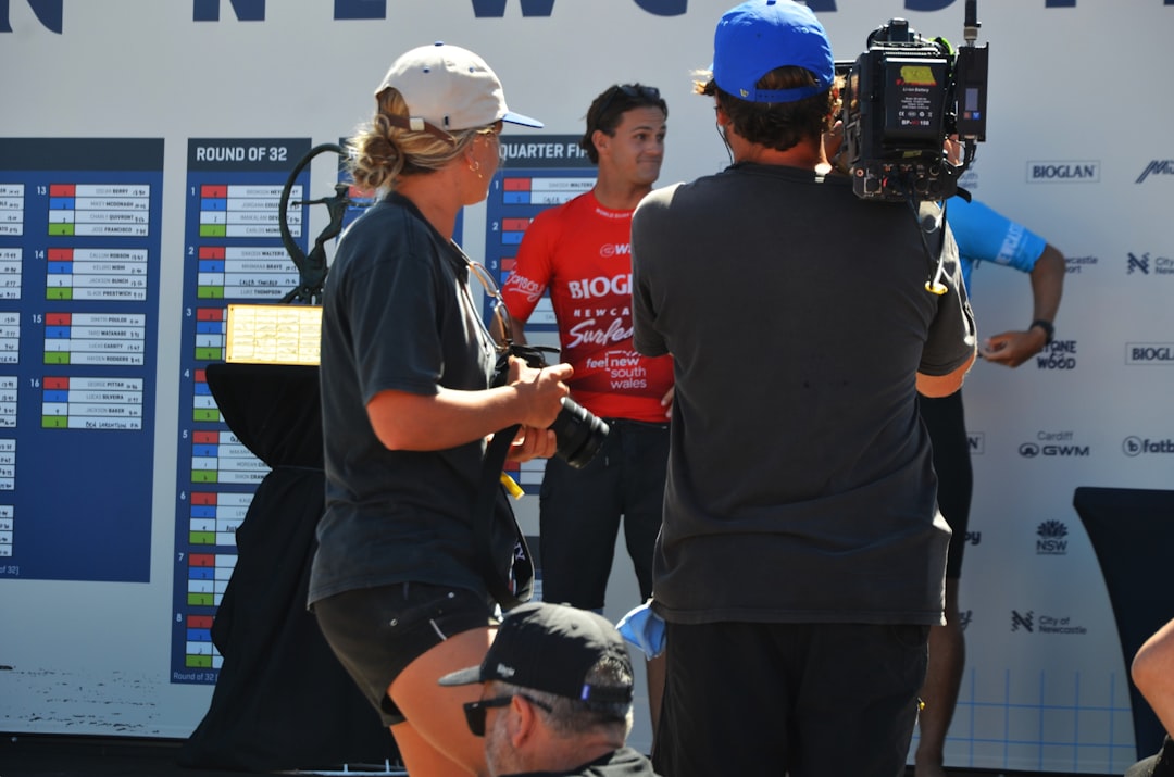 People at an outdoor event with a camera operator
