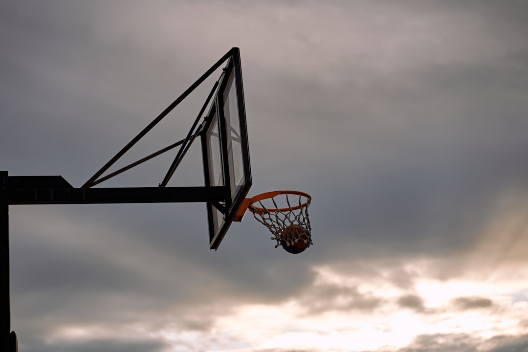 Basketball hoop against a cloudy sky