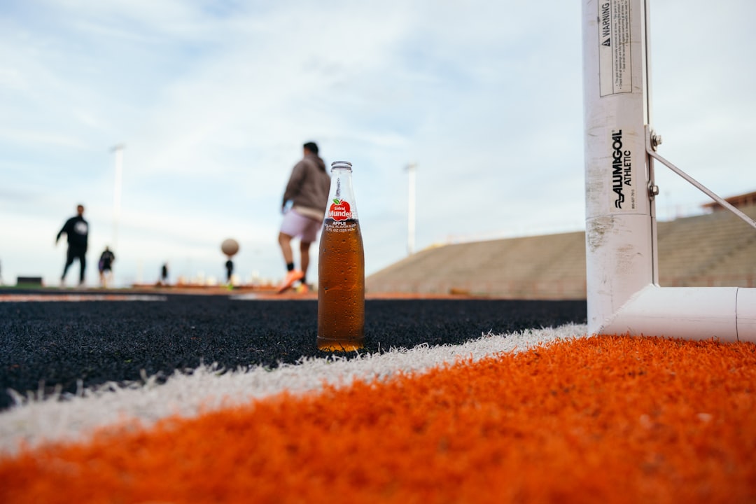 a bottle of beer sitting on top of a field