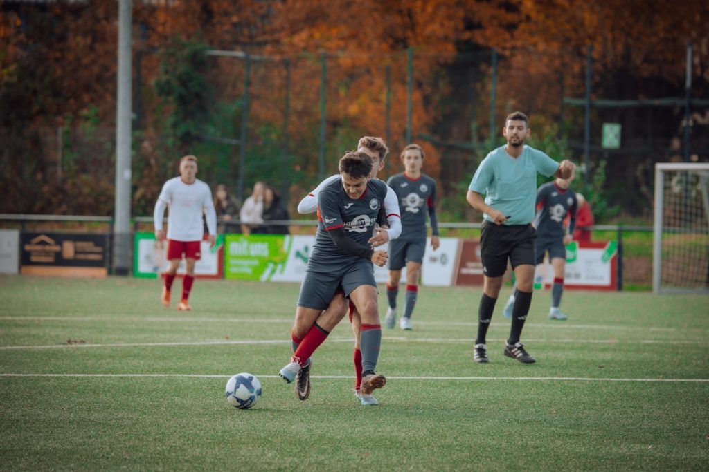 a group of young people playing a game of soccer