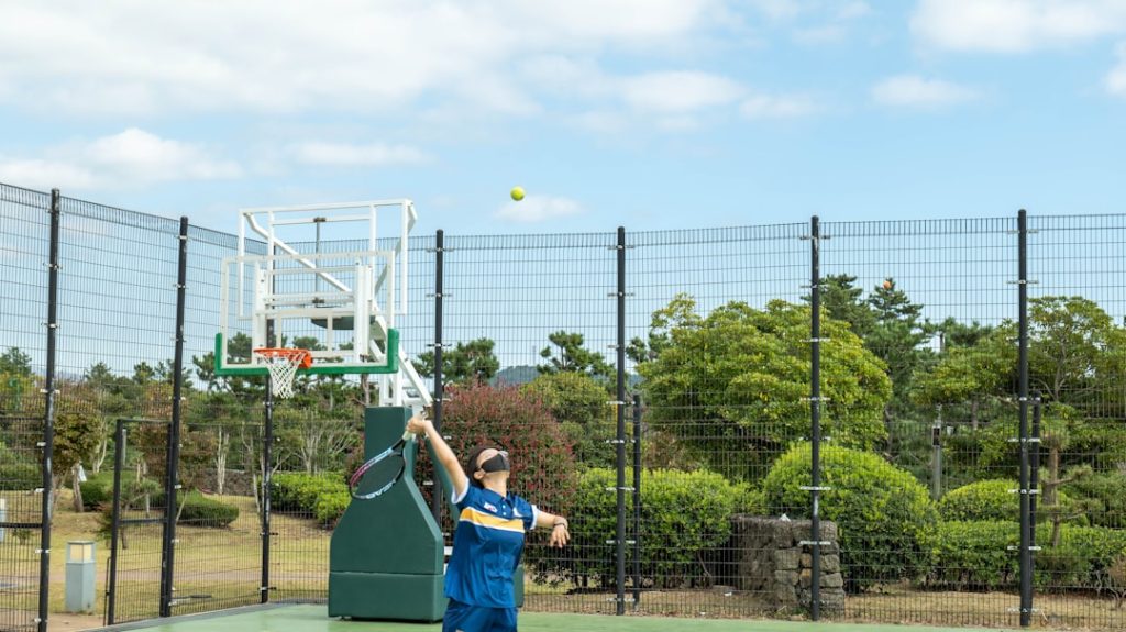 a person on a court with a tennis racket