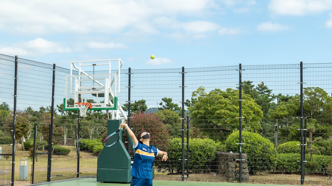 a person on a court with a tennis racket