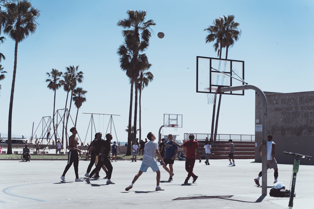 men playing basketball during day