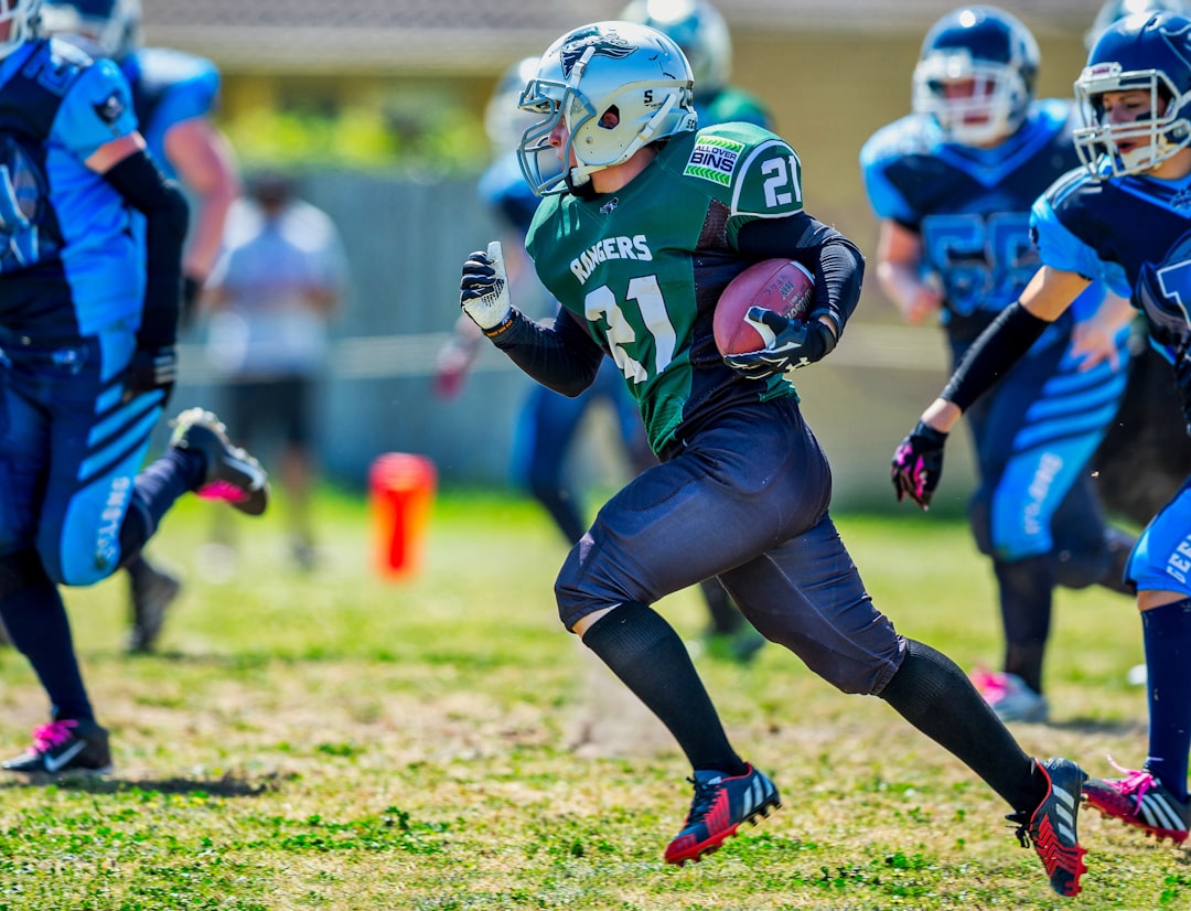 football game on grass field during daytime