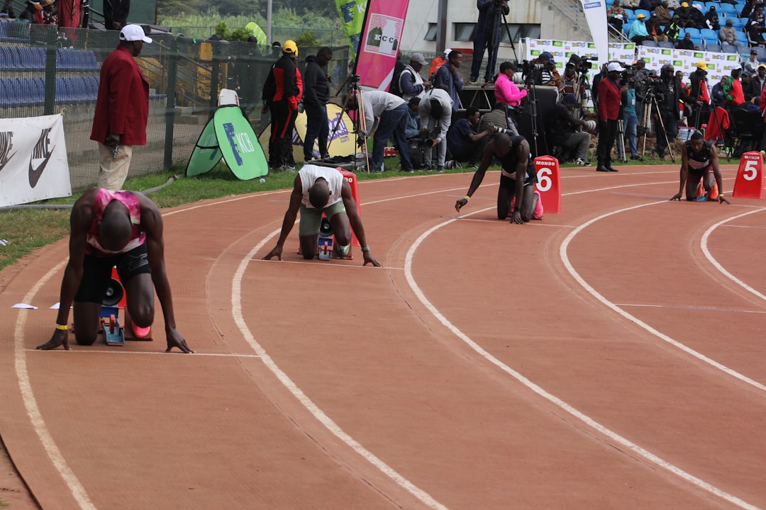 Athletes in starting blocks on a race track.