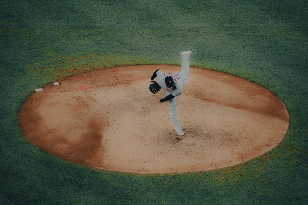 A baseball player pitching a ball on top of a field