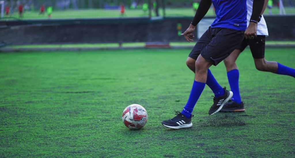 A couple of men playing a game of soccer