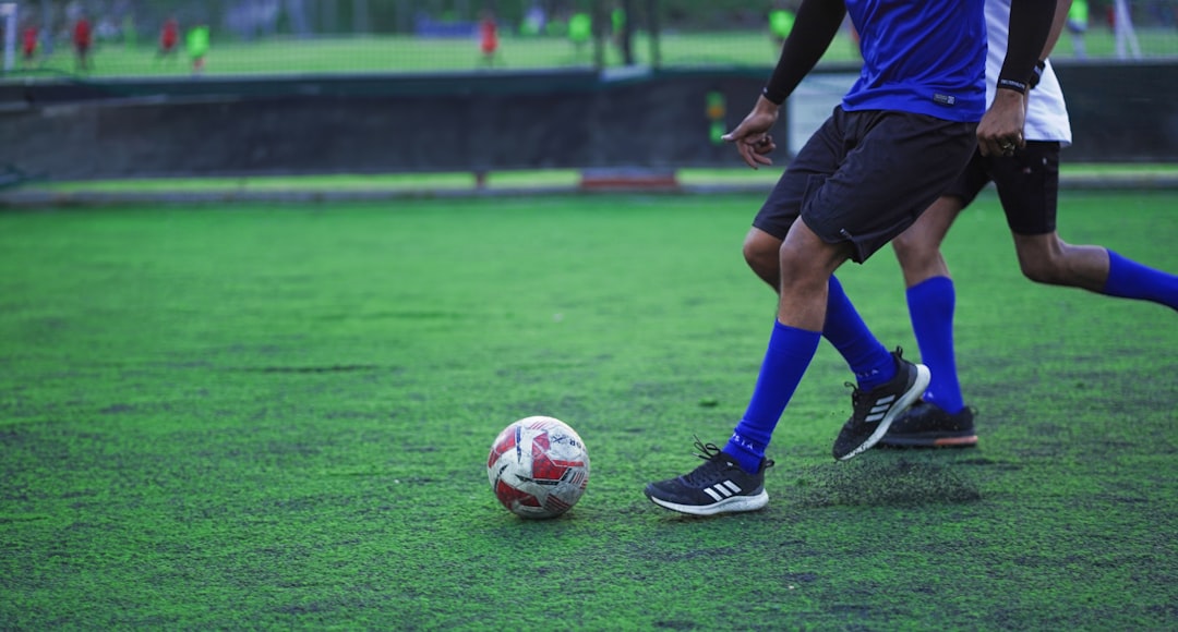 A couple of men playing a game of soccer