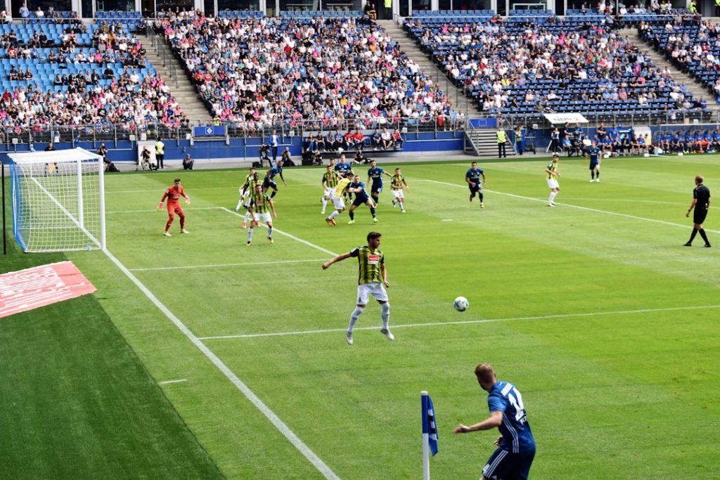 men playing soccer of soccer field during daytime