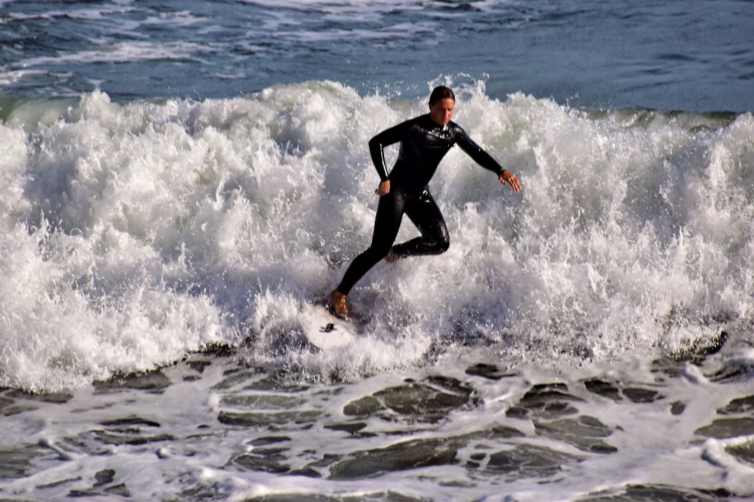 Surfer riding a wave in a wetsuit