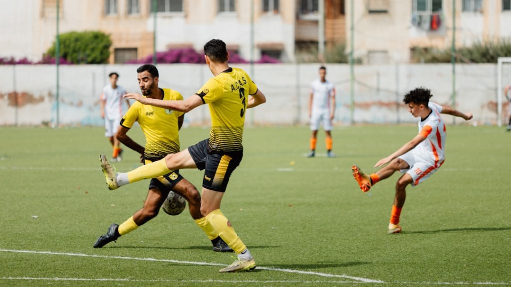 Soccer players compete in a game on the field.