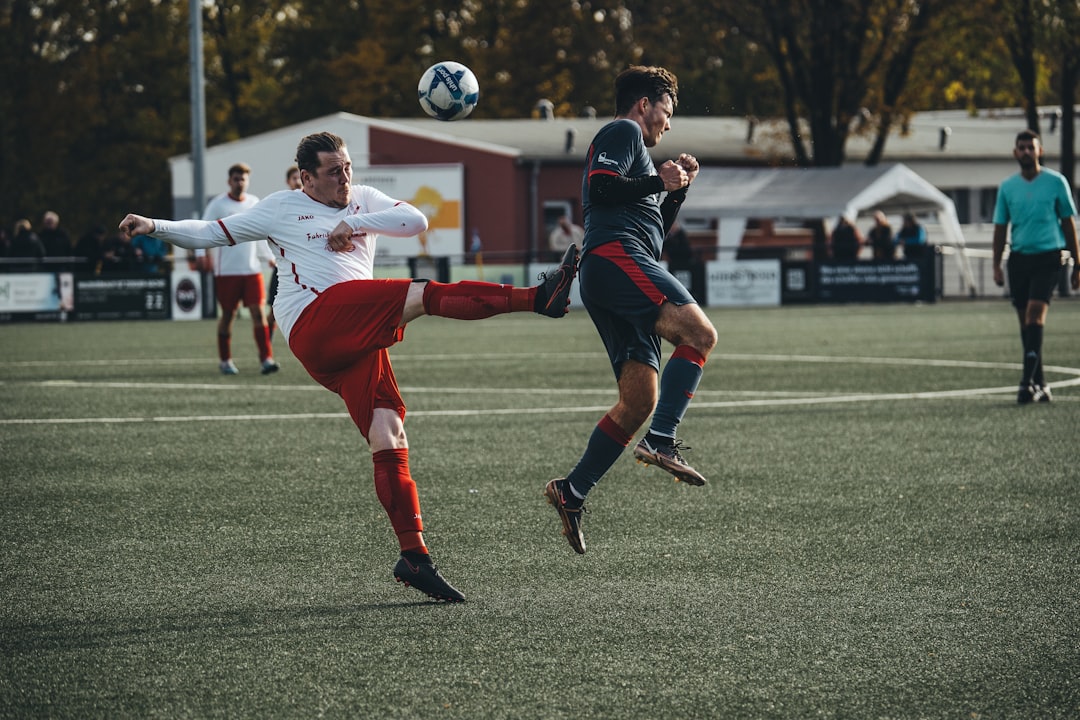a couple of men playing a game of soccer