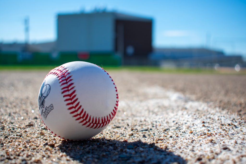 A baseball sitting on top of a baseball field