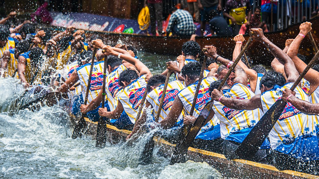 Team rowing a long boat during a race