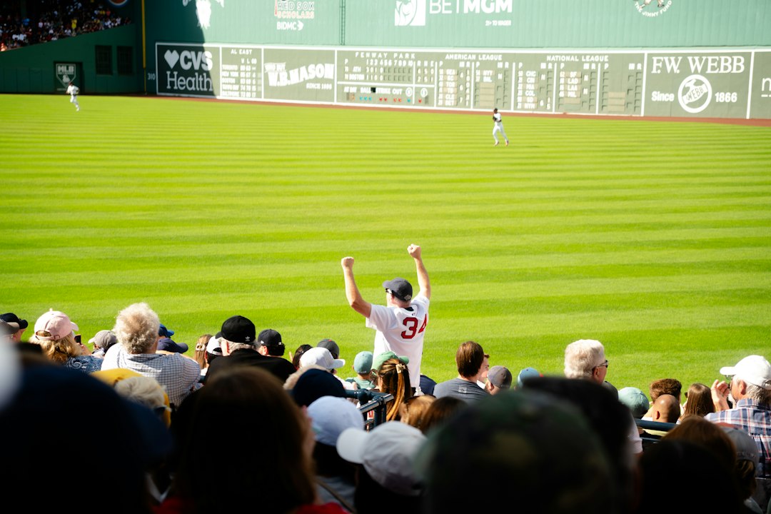 Baseball player celebrates on field with fans watching