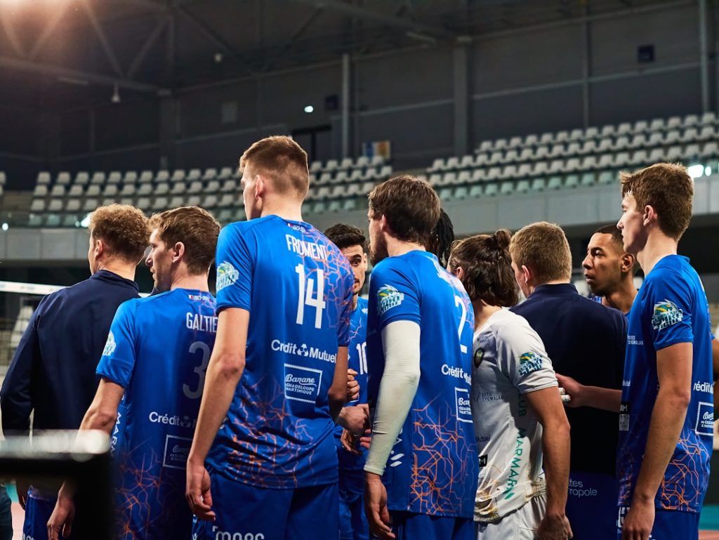 A group of men standing around each other