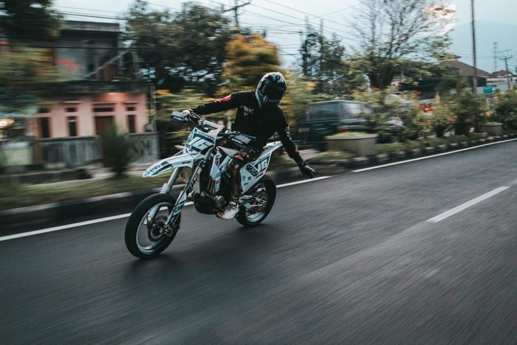a person riding a motorcycle down a street
