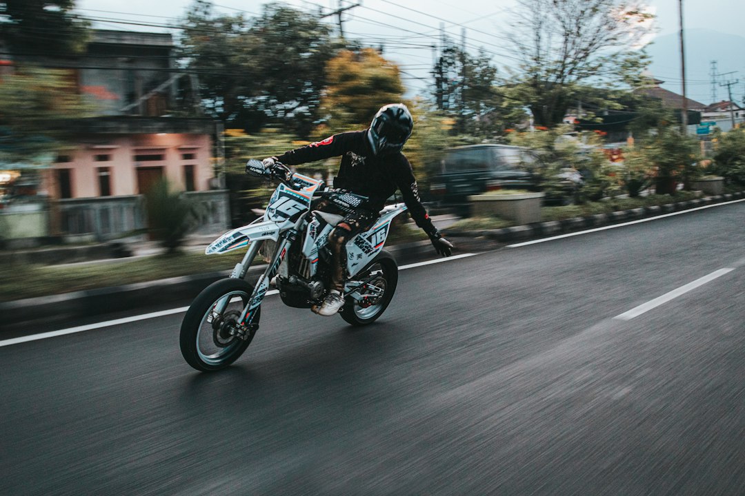 a person riding a motorcycle down a street