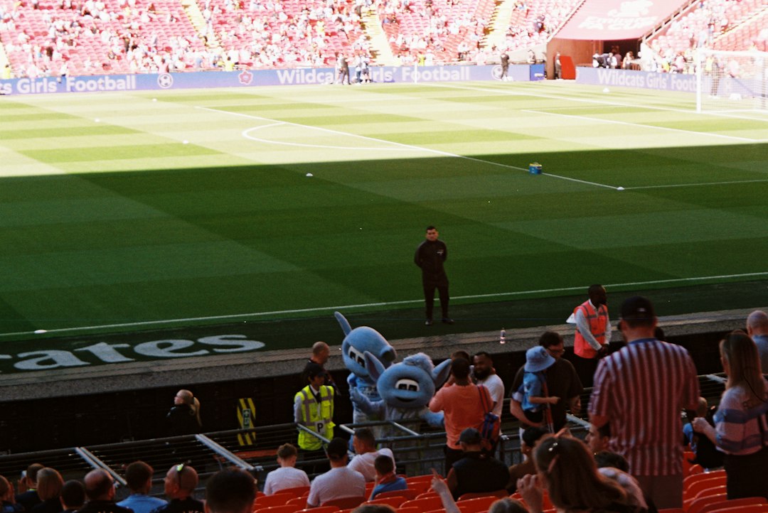 Mascot and spectators at a sunny outdoor stadium event