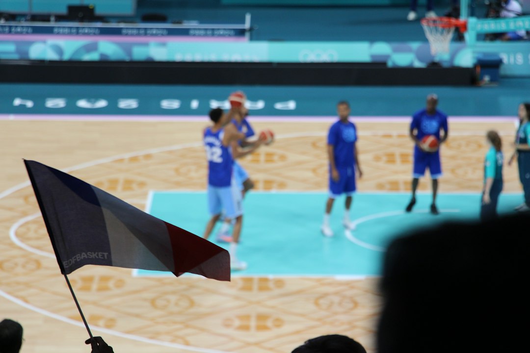 Basketball players on court with french flag