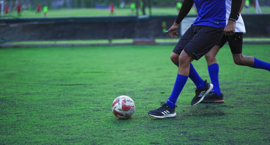 A couple of men playing a game of soccer