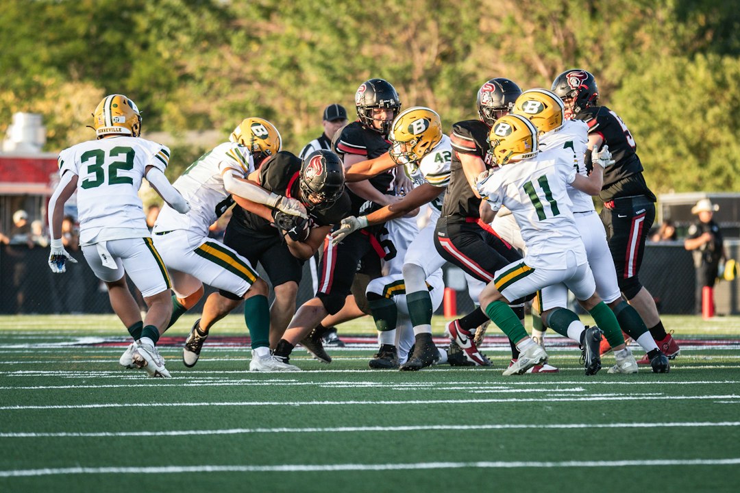 A group of football players playing a game of football