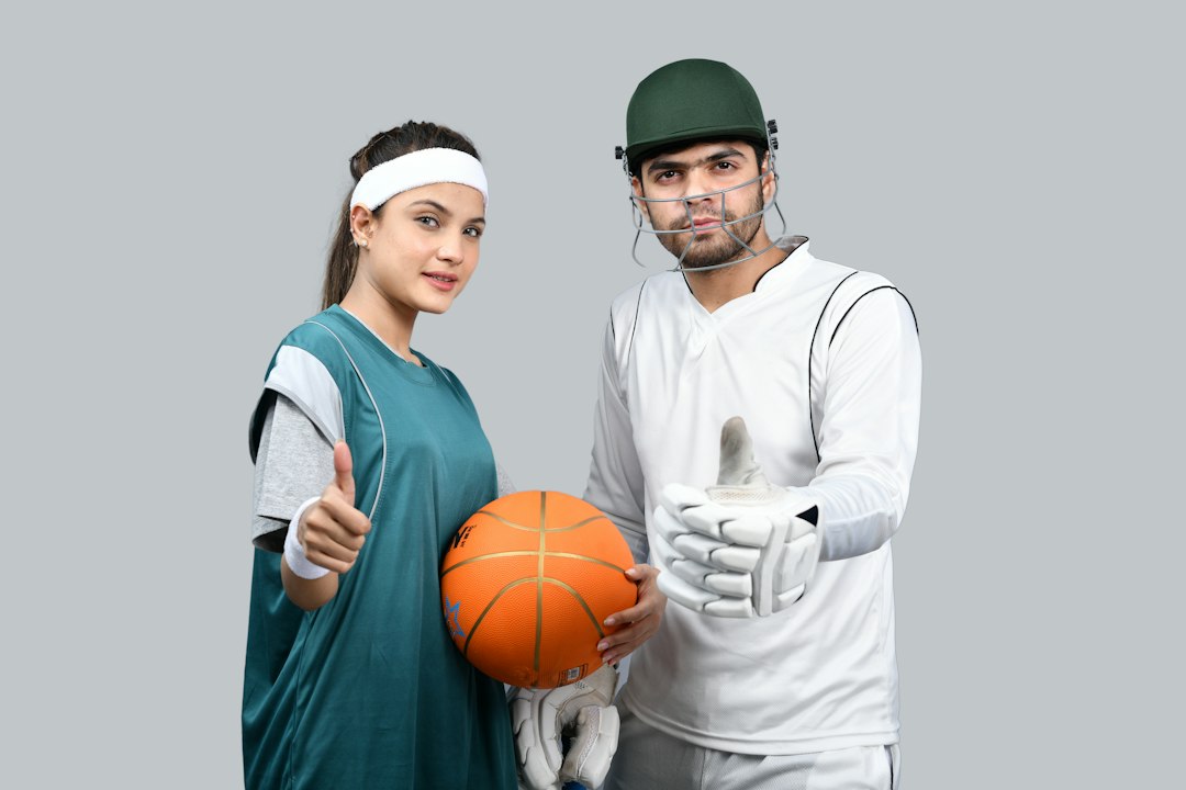 a man and a woman holding a basketball