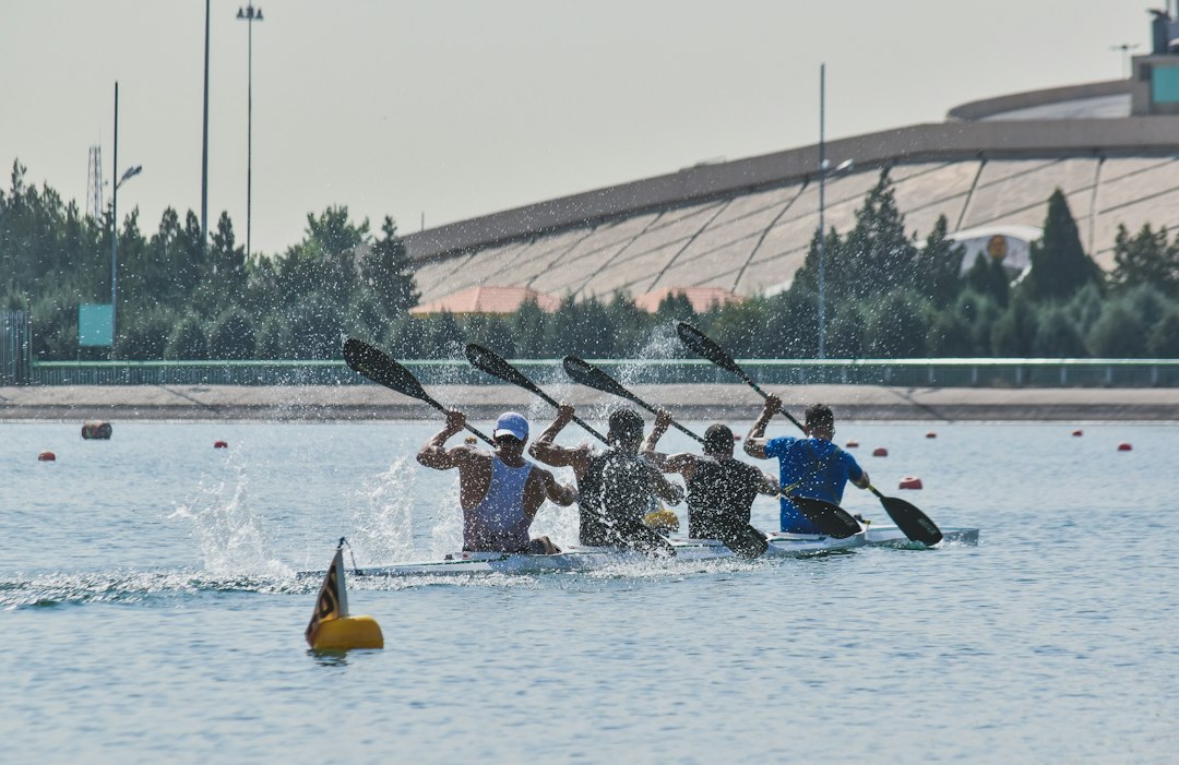 four men paddling kayak