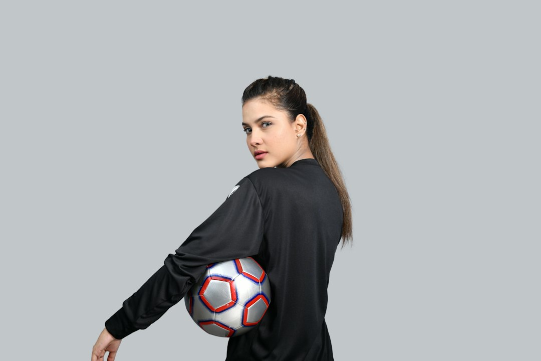a person holding a football ball