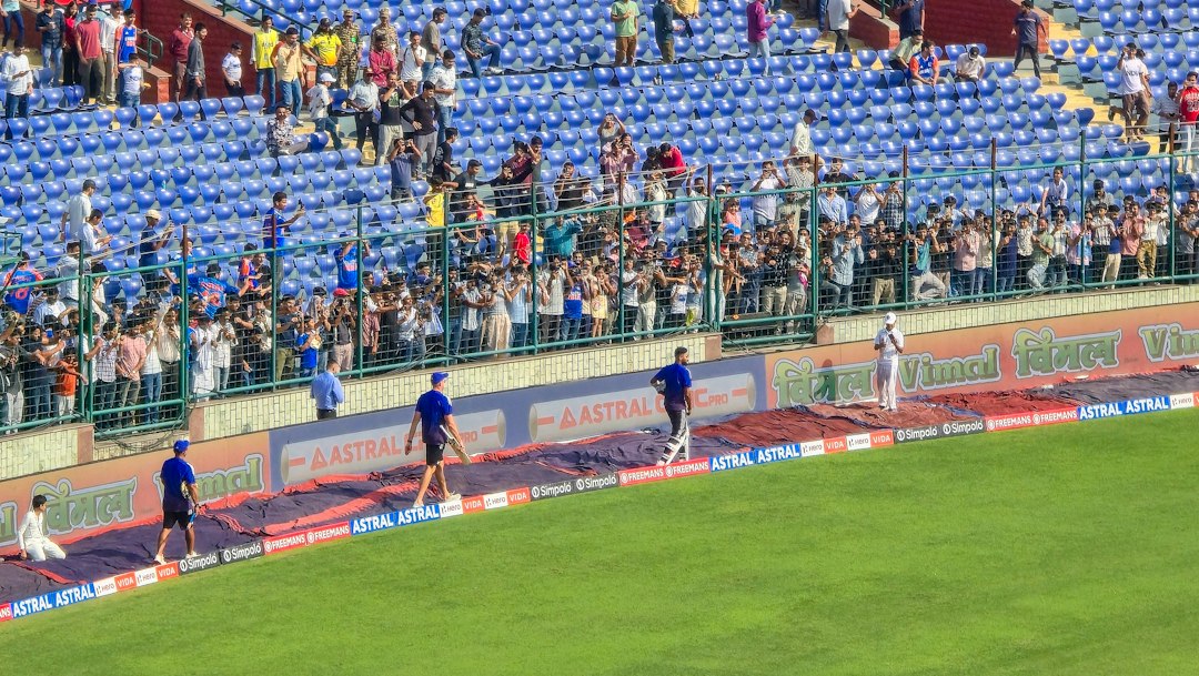 Spectators watch a game from stadium bleachers