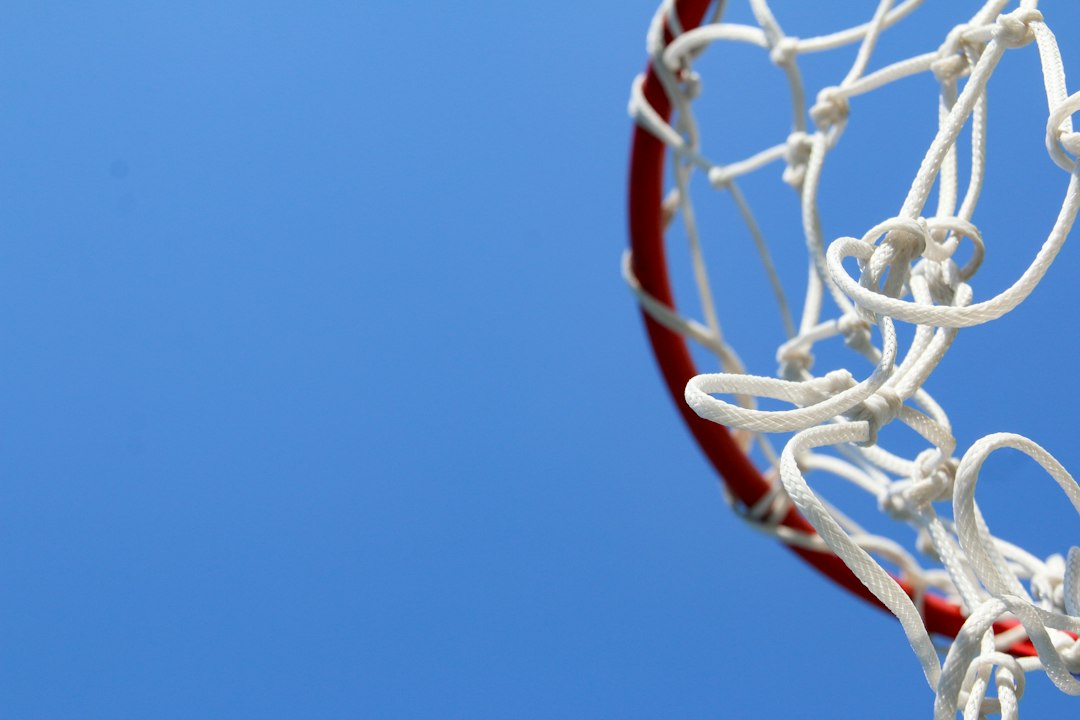 A basketball going through the rim of a basketball hoop