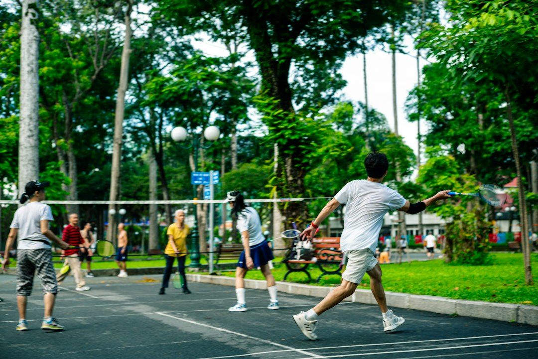 People playing badminton in a park